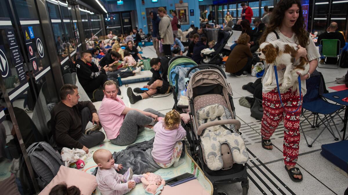 People take shelter in an underground metro station as air raid sirens warn of incoming strikes by Iran, in Ramat Gan, Israel, Saturday, Feb. 28, 2026. (AP Photo/Oded Balilty)